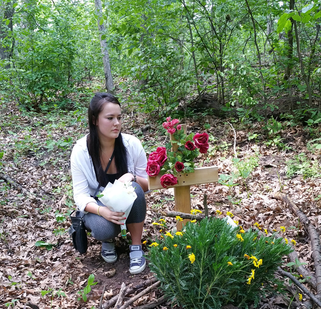 Elijah's girlfriend Madison visits the woods where he died